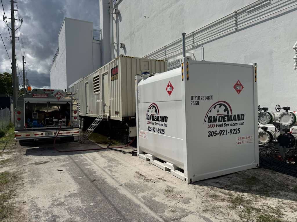 Fuel delivery truck servicing equipment outside